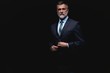 © opolja - Handsome mature business man isolated on black background
