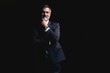 © opolja - Handsome mature business man isolated on black background