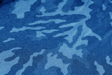 Old camouflage cloth with blur effect in navy blue tone.