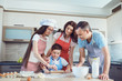 © Studio Romantic - A happy family prepares baking in the kitchen