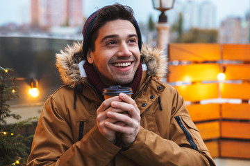 Wall Mural - Happy young man standing posing outdoors winter concept.