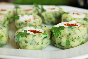 Wall Mural - Potato balls with chive, parsley, and spices serving with fresh yogurt