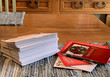 © MightyBlue - Stack of Christmas greeting cards ready to be placed in the mail with a few cards and pen laying next to them on country kitchen table