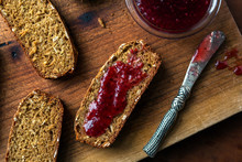 Close Up Of Jam With Brown Soda Bread On Cutting Board