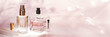 Different perfume bottles and sampler on a pink floral background. Perfumery collection, cosmetics Banner