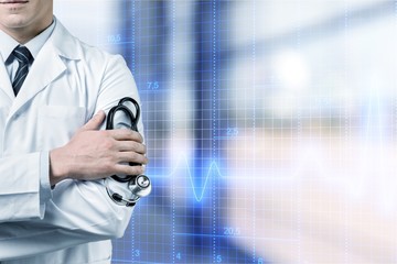 Wall Mural - Portrait of  doctor  with arms crossed in medical office