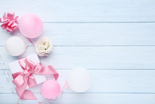 Gift Box With Balloons And Eustoma Flowers On Wooden Table