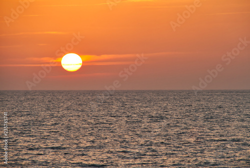 Fotografia, Obraz The sun setting over the Atlantic Ocean as seen from Spain.