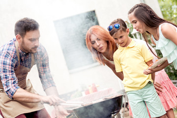 Wall Mural - Young family make barbecue at their home