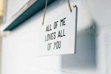 Wooden board with text all of me loves all of you, love sign on the wall home interior modern