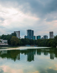 Wall Mural - Buildings reflected on water at the sunset