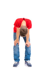 Wall Mural - Full length portrait of tired teen boy, isolated on white background. Sad teenager grounded looking down, posing at studio. 