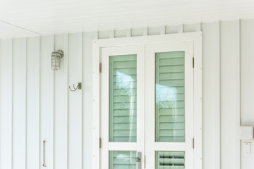 pastel green colorful hurricane window shutters architecture open exterior of house in florida beach