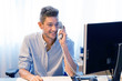 © polack - Social worker talking on the phone. Close-up male an state institution worker. Man secretary hospital answering phone calls and talking with customers, she is sitting at her desk working.