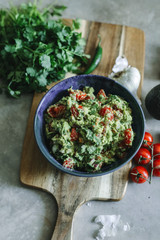 Wall Mural - Homemade guacamole with cherry tomatoes food photography recipe idea