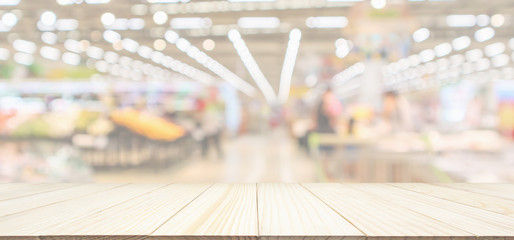 Wall Mural - Wood table top with supermarket grocery store blurred defocused panorama background with bokeh light for product display