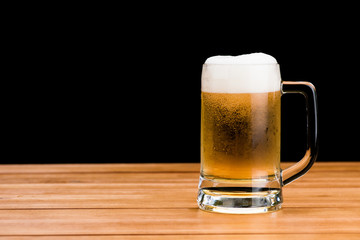 Wall Mural - Glass of beer on wood table isolated on black background , drinking alcohol celebration object concept design