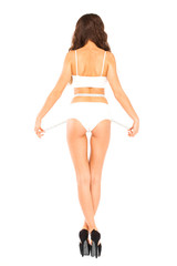 Wall Mural - Young beautiful woman in white fitness clothing