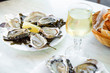 © The Picture Pantry - Raw oysters served in a french restaurant with lemon slices, wine, baguette and butter