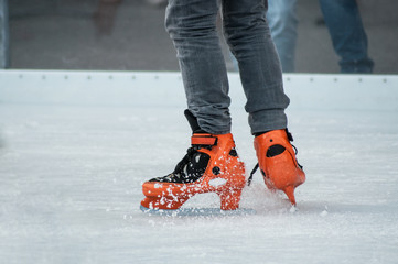 retail of legs of man slipping on an ice christmas rink