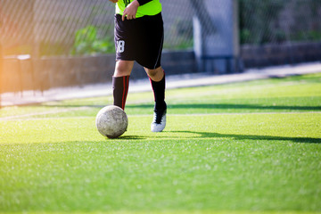 Sticker - Soccer player speed run to shoot ball to goal on artificial turf.