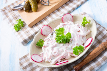 delicious homemade meat salad with mayonnaise and cucumber