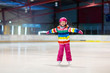 © famveldman - Child skating on indoor ice rink. Kids skate.