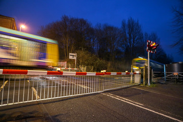 Wall Mural - Barriers down at the level crossing