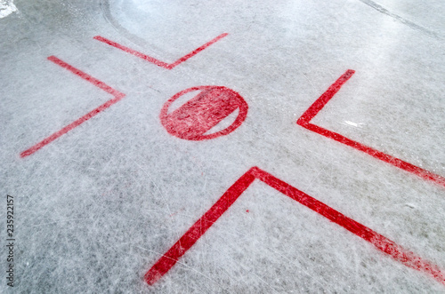 Fototapeta na szkło Hockey rink with faceoff spot on freshly resurfaced ice with marks of water