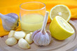 Healthy lemon drink and fresh garlic.