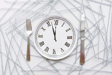 Wall Mural - Festive table setting with clock plate. Knife and fork.Christmas decorations. New Year. 