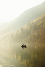 Three People Fishing In Lake