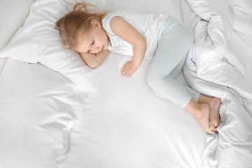 Wall Mural - Little girl lying on white pillow at home