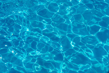  Water ripples and pattern on swimming pool surface with sunlight reflection