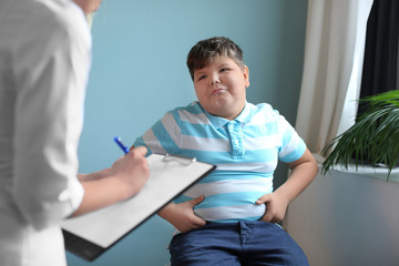 Overweight boy consulting with doctor in office