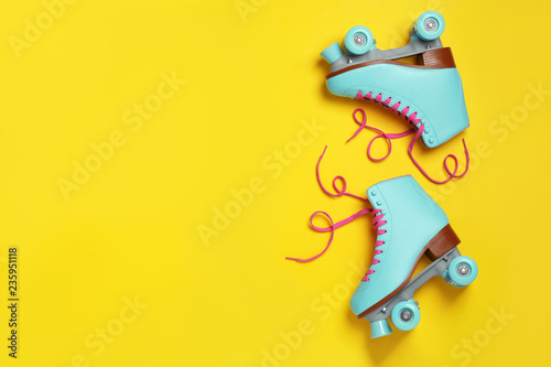 Fotografía Pair of stylish quad roller skates on color background, top view with space for
