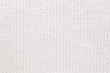 Abstract knitted background. White woolen sweater texture. Close up picture of  knitted pattern.