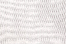 Abstract Knitted Background. White Woolen Sweater Texture. Close Up Picture Of  Knitted Pattern.