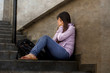 © TheVisualsYouNeed - depressed student woman or bullied teenager girl sitting outdoors on street staircase scared and anxious victim of bullying feeling desperate suffering depression
