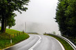 © Denis - Beautiful mountain road in Austria. Misty forest and cloudy sky in background.