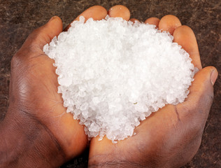 Poster - MAN HOLDING ROCK SALT GRANULES