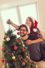 Wall Mural - Couple decorating Christmas tree