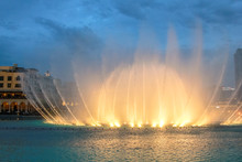 Night View Of The Light Show At Dubai Dancing Fountain. The Dubai Fountain, The World Largest Choreographed Fountain On Burj Khalifa Lake Area, Performs To The Beat Of The Selected Music.