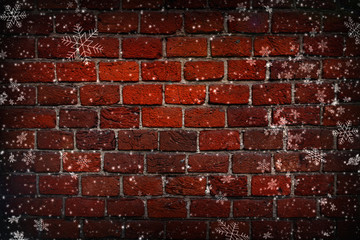 Abstract Christmas background. Red brick wall close-up, texture, background, grunge. White snowflakes on brick wall background. Vignette, copy space