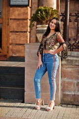 Wall Mural - Pretty latino model girl from Ecuador wear on jeans posed at street.