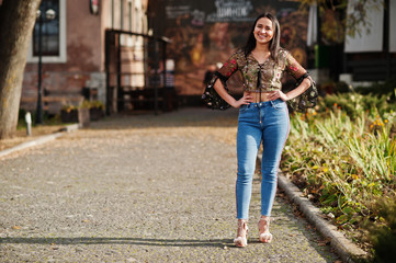 Wall Mural - Pretty latino model girl from Ecuador wear on jeans posed at street.