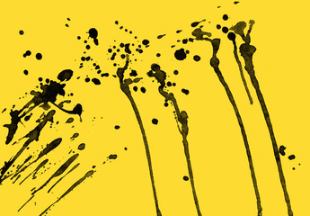 Isolated artistic black watercolor and ink paint splatter textures and decorative elements on yellow paper background.