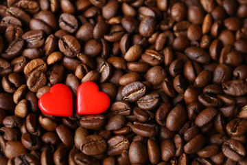 Roasted coffee beans and two red hearts. Concept of romantic breakfast, love to coffee, Valentines day, menu background