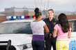 Policewoman talking to two young girls