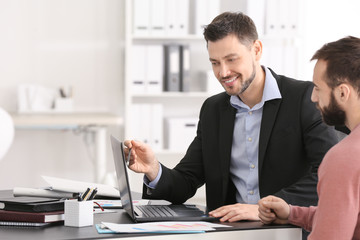 Sticker - Businessman consulting young man in office